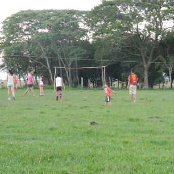 Notice the little tyke right of center during evening girls' futbol practice. Kids and young boys play with girls until they are old/strong enough to play with the teens and young men.
